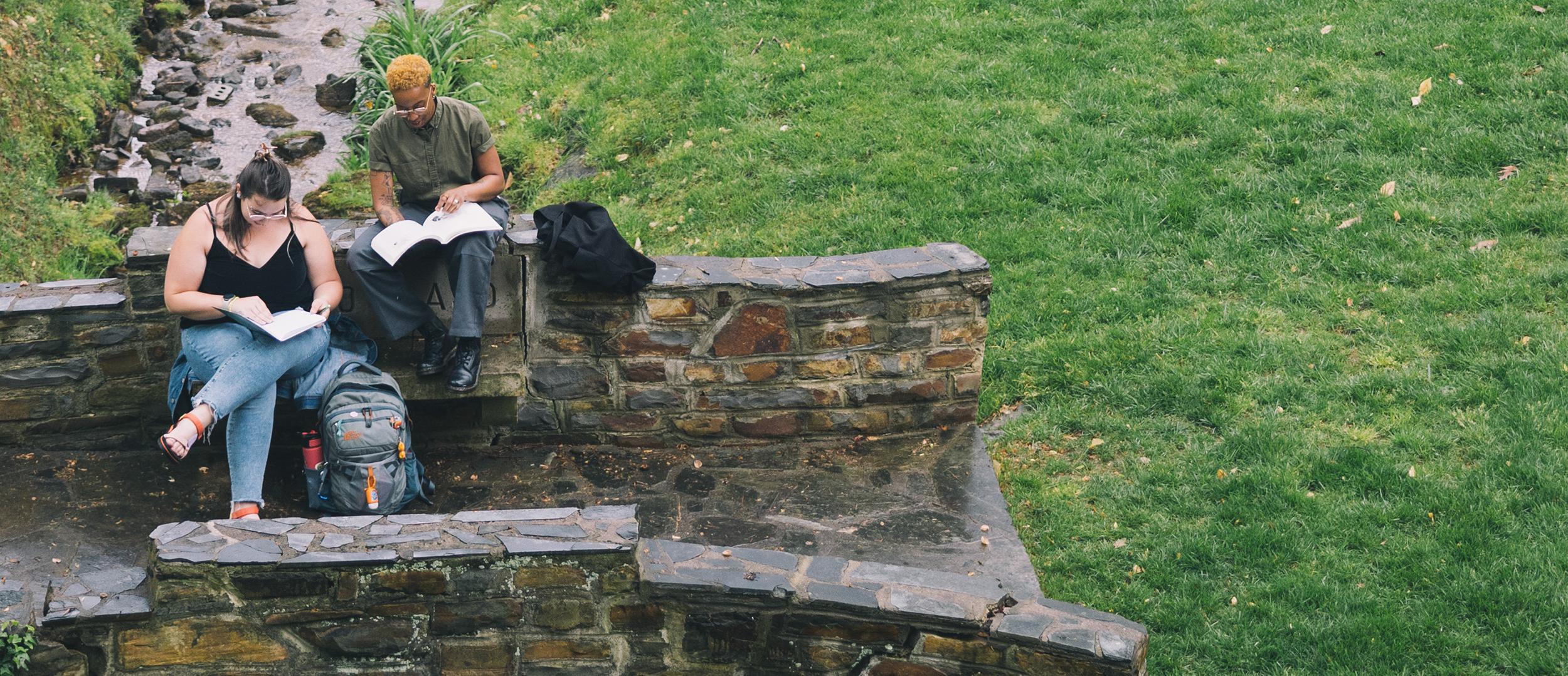 Two students sitting in the May Dell